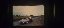 JU04 35MM SLIDE Photo photograph MAN STANDS NEXT TO OLDS CUTLASS ON SIDE OF ROAD picture