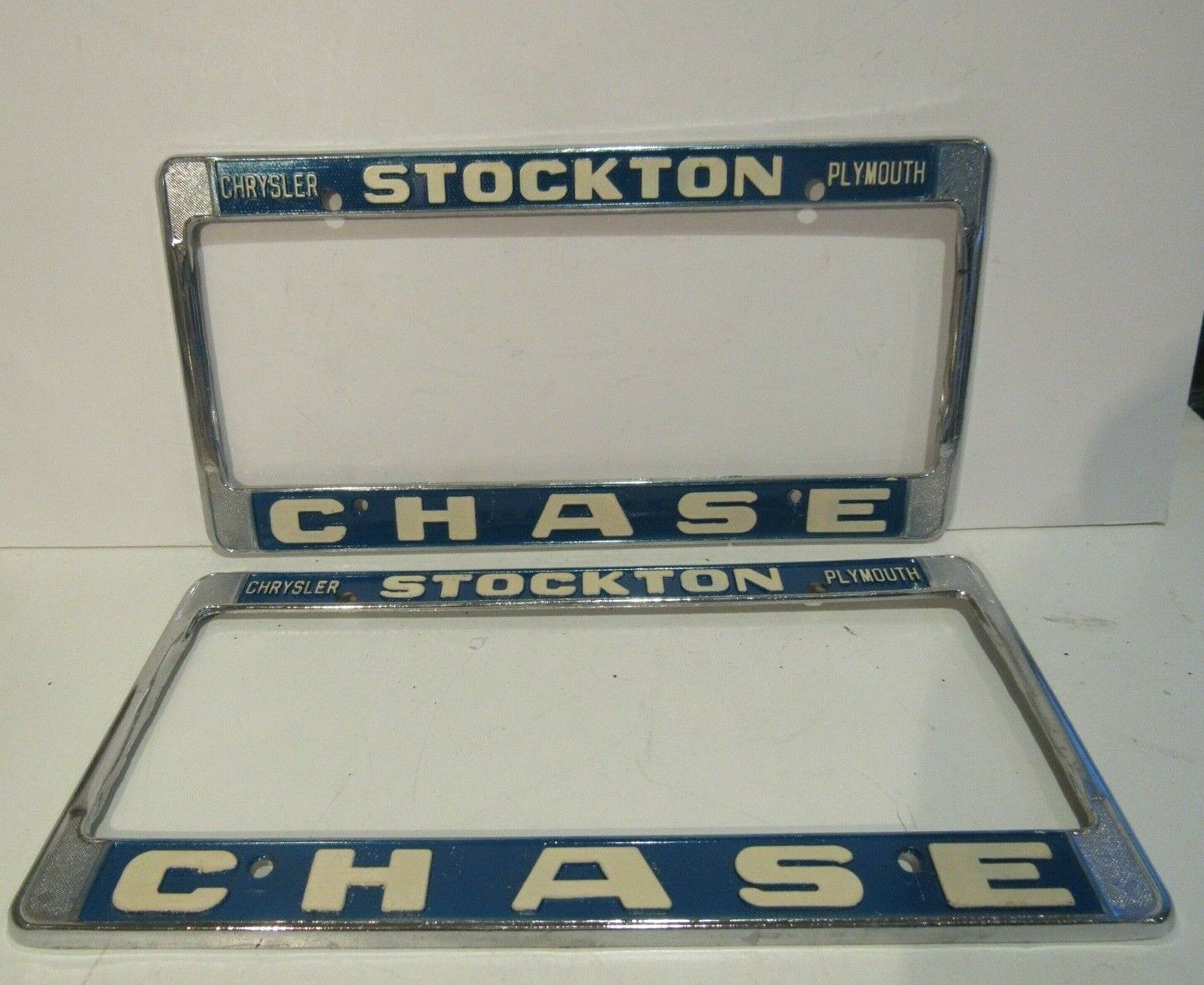 Vintage PAIR Stockton Chrysler Plymouth CHASE License Plate Frame Metal Embossed