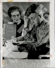 1973 A grandmother and grandson are studying a book together picture