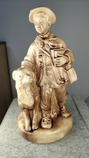 Vintage antique figurine. Hutsul boy with a dog picture