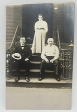 Vintage B&W RPPC Two Men Woman Sitting on Stairs Top Hat Floating Hat Postcard picture
