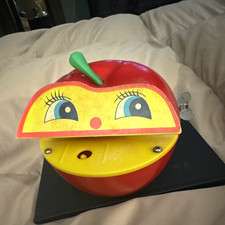 Vintage Wind-Up Apple Shaped Coin Bank w/ Face, Red/Yellow Plastic NON WORKING picture
