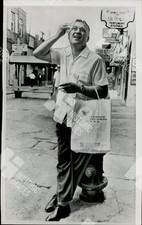 1967 Alaska Governor Walter J. Hickel posing in a street with a shopping bag picture