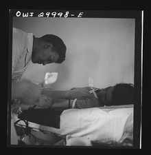 Photo:1930s Doctor Examining Child Patient Hospital Bed picture