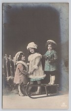 RPPC Three Adorable Children Sled - Winter Scene Hand-Tinted Postcard c1910 picture