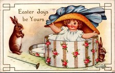 Postcard Easter Joys Be Yours Little Girl Coming Out of Hat Box Baby Rabbits  picture