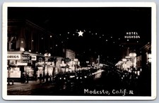 K38/ Modesto California Postcard RPPC c1940-50s Night Main Street Stores 59 picture