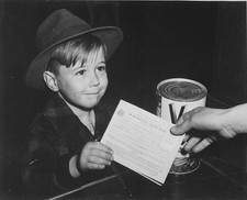 A young school boy using a War Ration Book 8