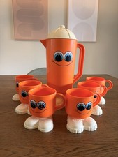 Vintage 1970s DEKA Footsie Tootsie Orange Pitcher & 6 Cups Smiley Face Set picture