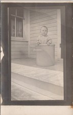 Baby Sitting in Stoneware Crock on Porch Real Photo Postcard c1930s RPPC picture