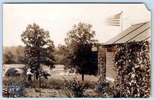 1907-10's RPPC AMERICAN FLAGS WOMAN IN GARDEN HOUSE LAKE PATRIOTIC POSTCARD picture