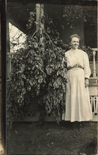 RPPC Woman  Giant Fruit Branch Lansing Michigan Bovee Harvest Postcard c1910 picture