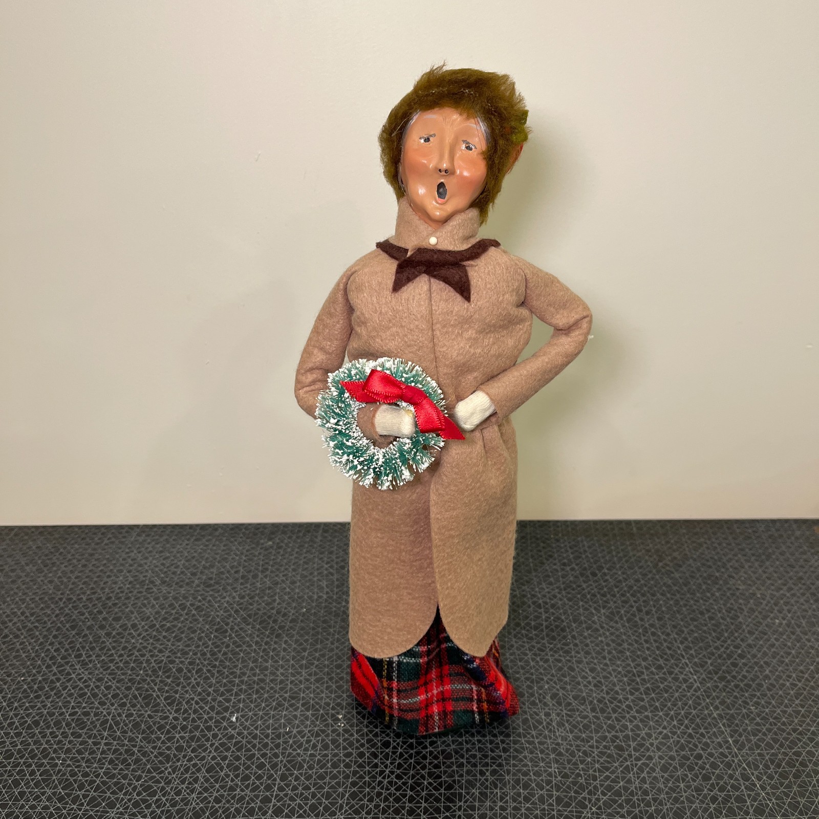 Byers Choice Caroler Woman with Wreath, Brown Trenchcoat, Fur Lined Cap, Plaid