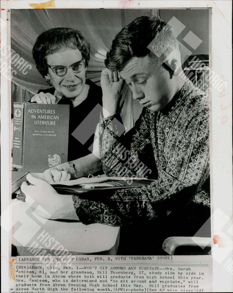 1973 A grandmother and grandson are studying a book together