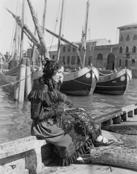 Woman Clad In Black Lace Sits In The Harbour Of Chioggiin Veneto - 1951 photo