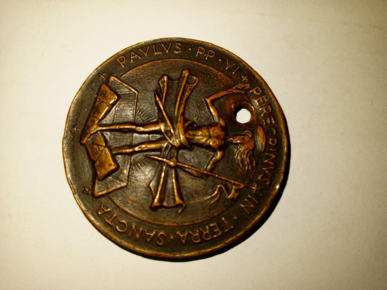 An old antique brass medallion, 1964, symbolizing the Christian religion