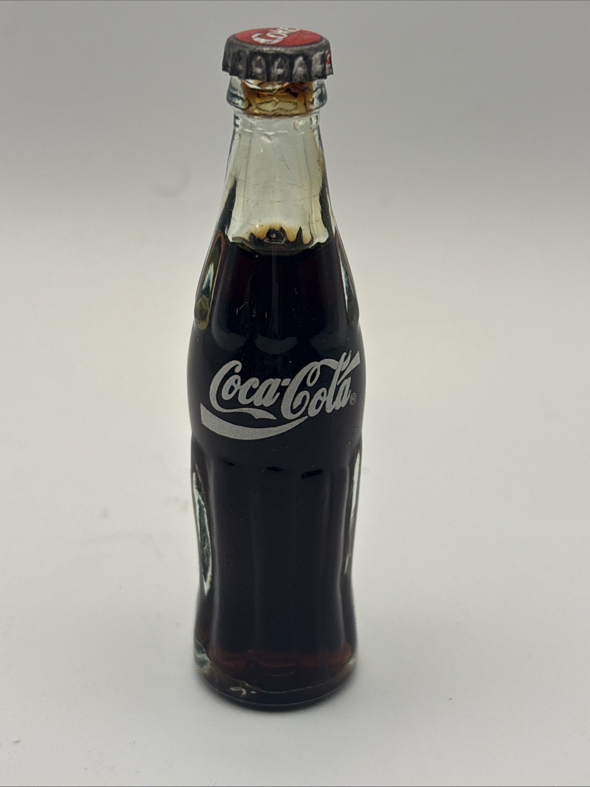 VTG MINI COCA-COLA GLASS BOTTLE, FULL W/ METAL CAP 3” Atlanta
