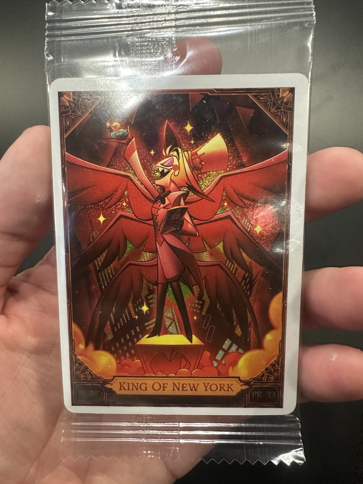 NYCC 2026 PSA HAZBIN HOTEL LUCIFER KING OF NEW YORK PROMO CARD IN HAND