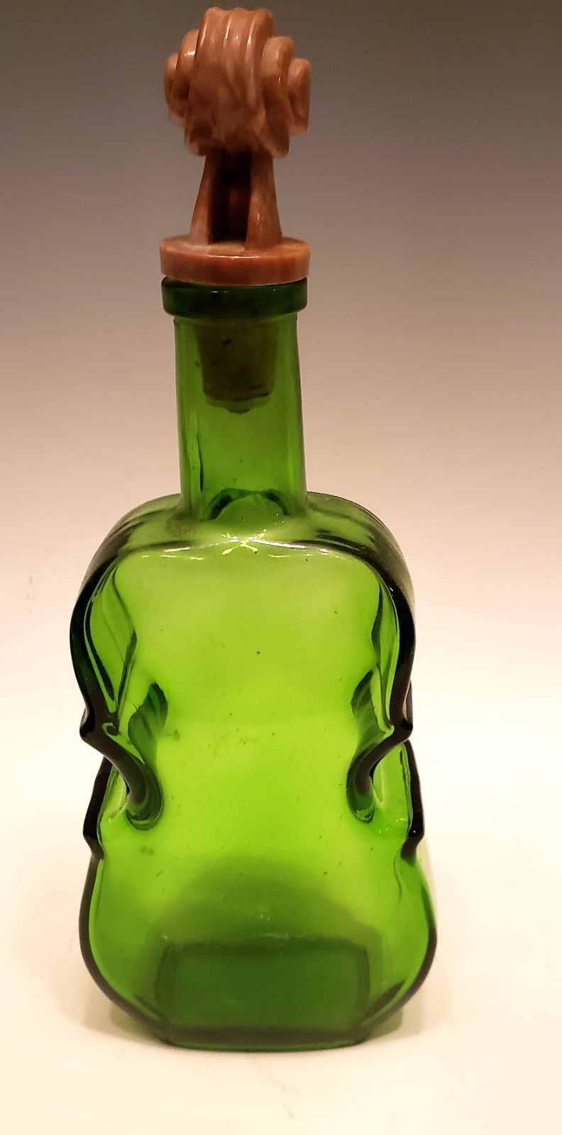 Vintage green cello shaped glass bottle with decorative stopper