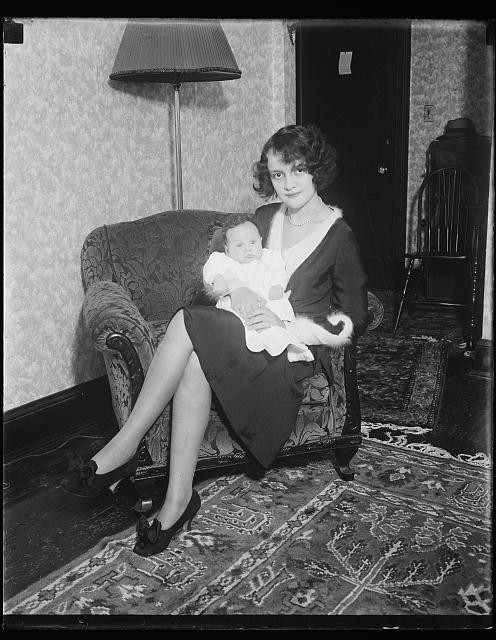 Photo:1910s Woman Holding Baby Indoor Portrait Living Room Armchair