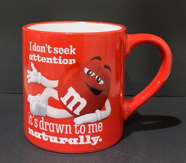 Nice Red M&M Coffee Mug “I Don\'t Seek Attention It\'s Drawn To Me Naturally”