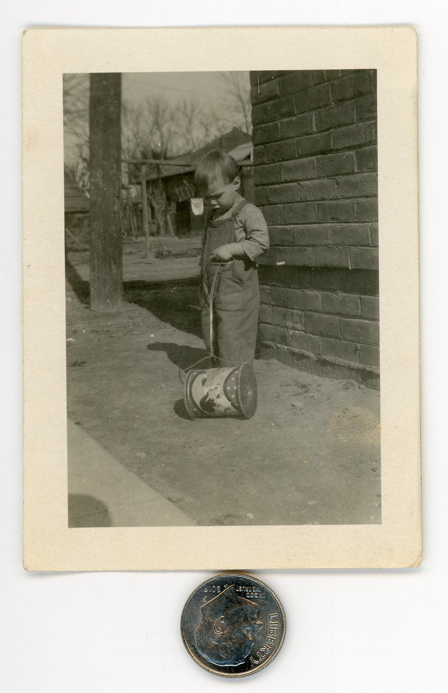 Old 1920's mini photo / Common Sense Farm Boy Can't Figure Out Purpose of Toy