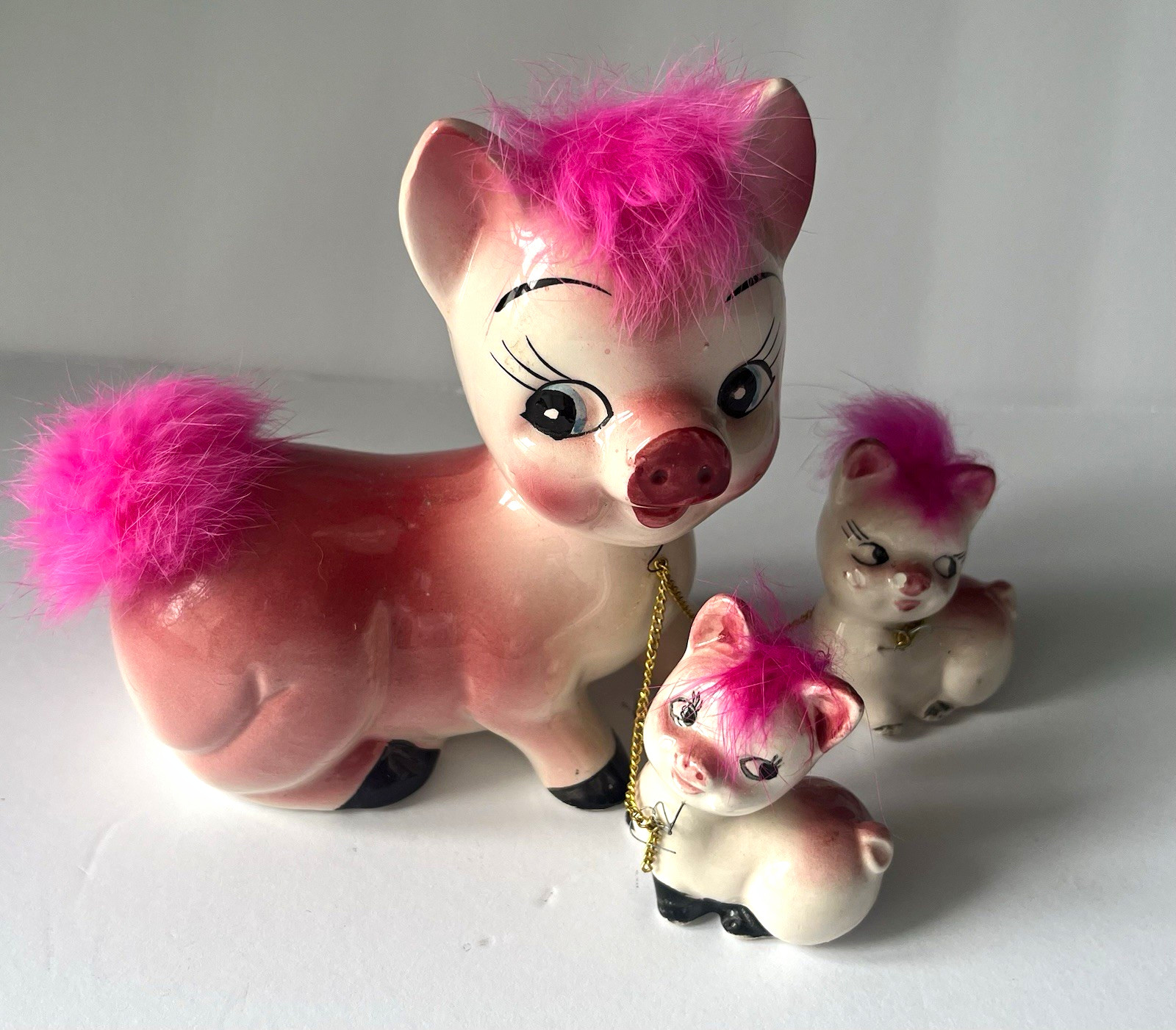vintage mid-century Ceramic Chained Pig Figurines featuring whimsical pink faux