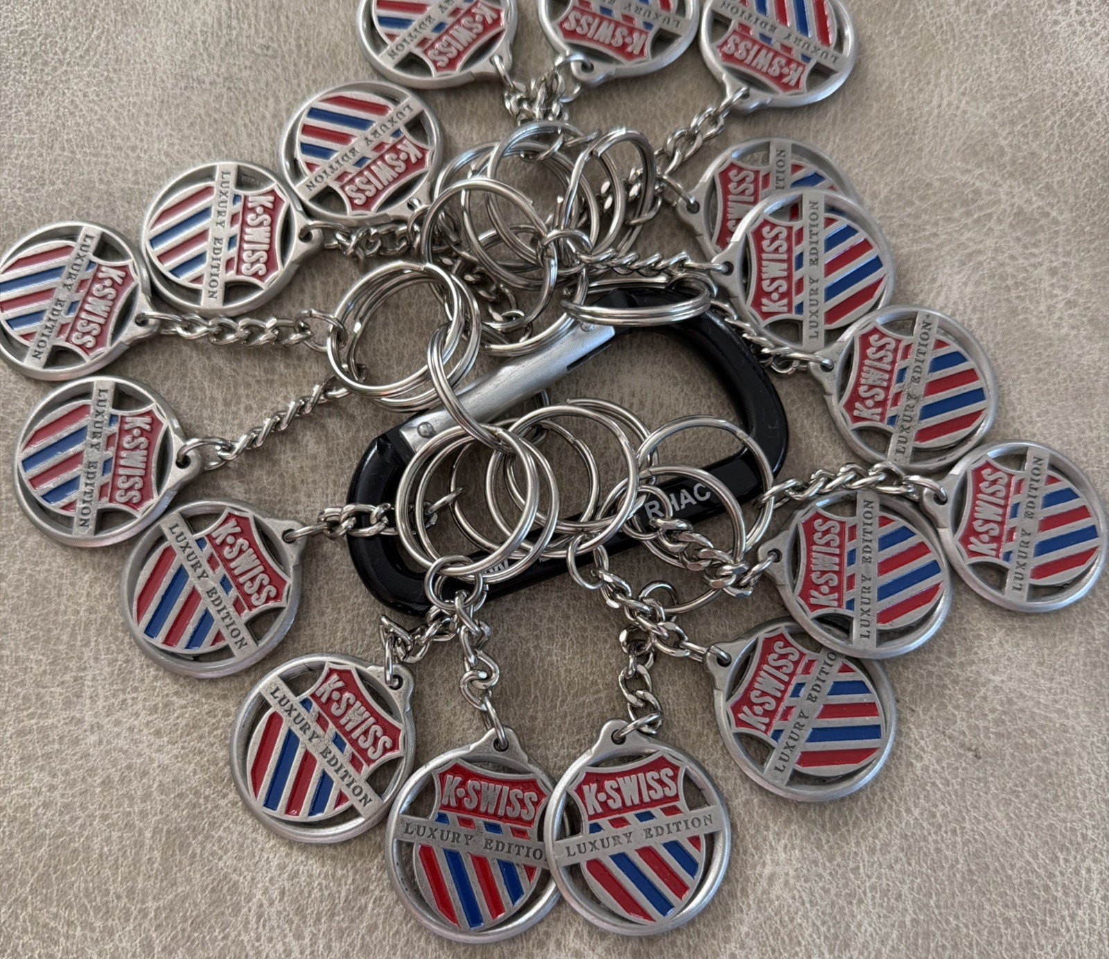 Lot of (17) K-Swiss Luxury Edition Metal Advertising Double Sided Key Chain
