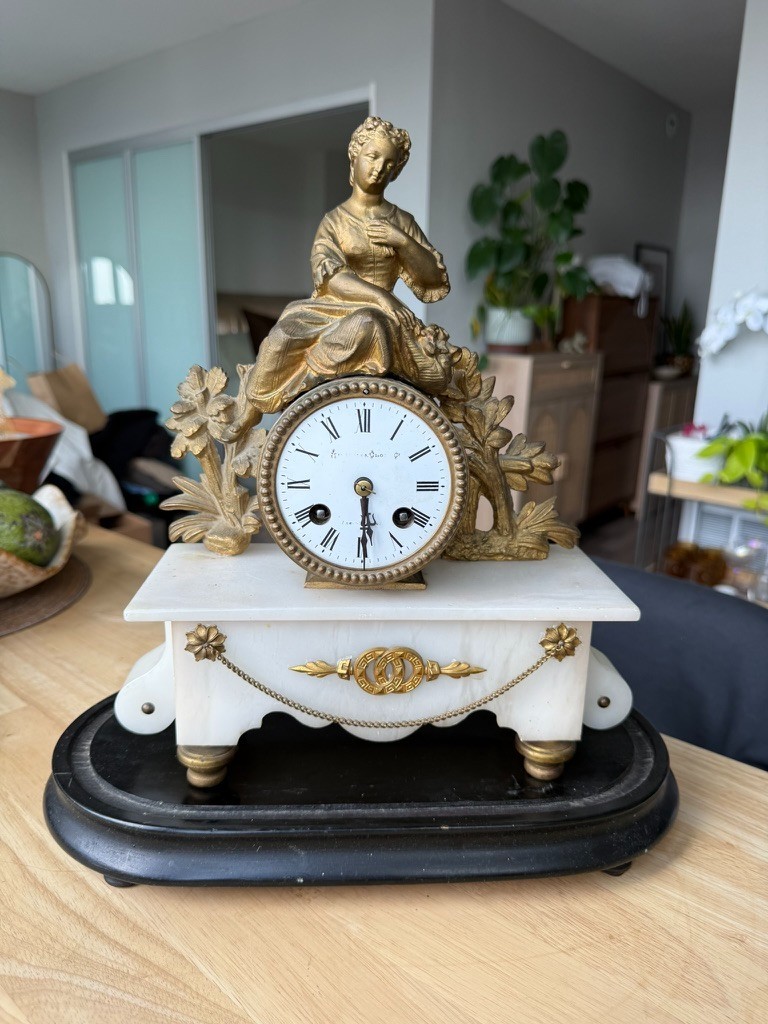 Antique 19th-century French figural mantel clock with a white marble