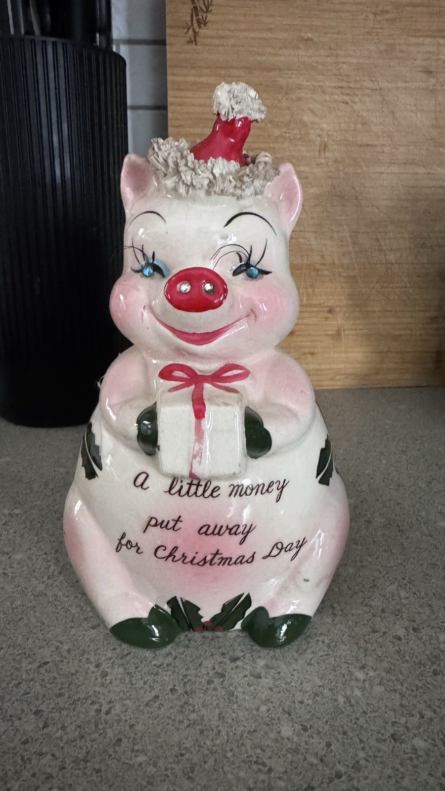 A vintage 1950s Kreiss ceramic Christmas piggy bank with rhinestone eyes.