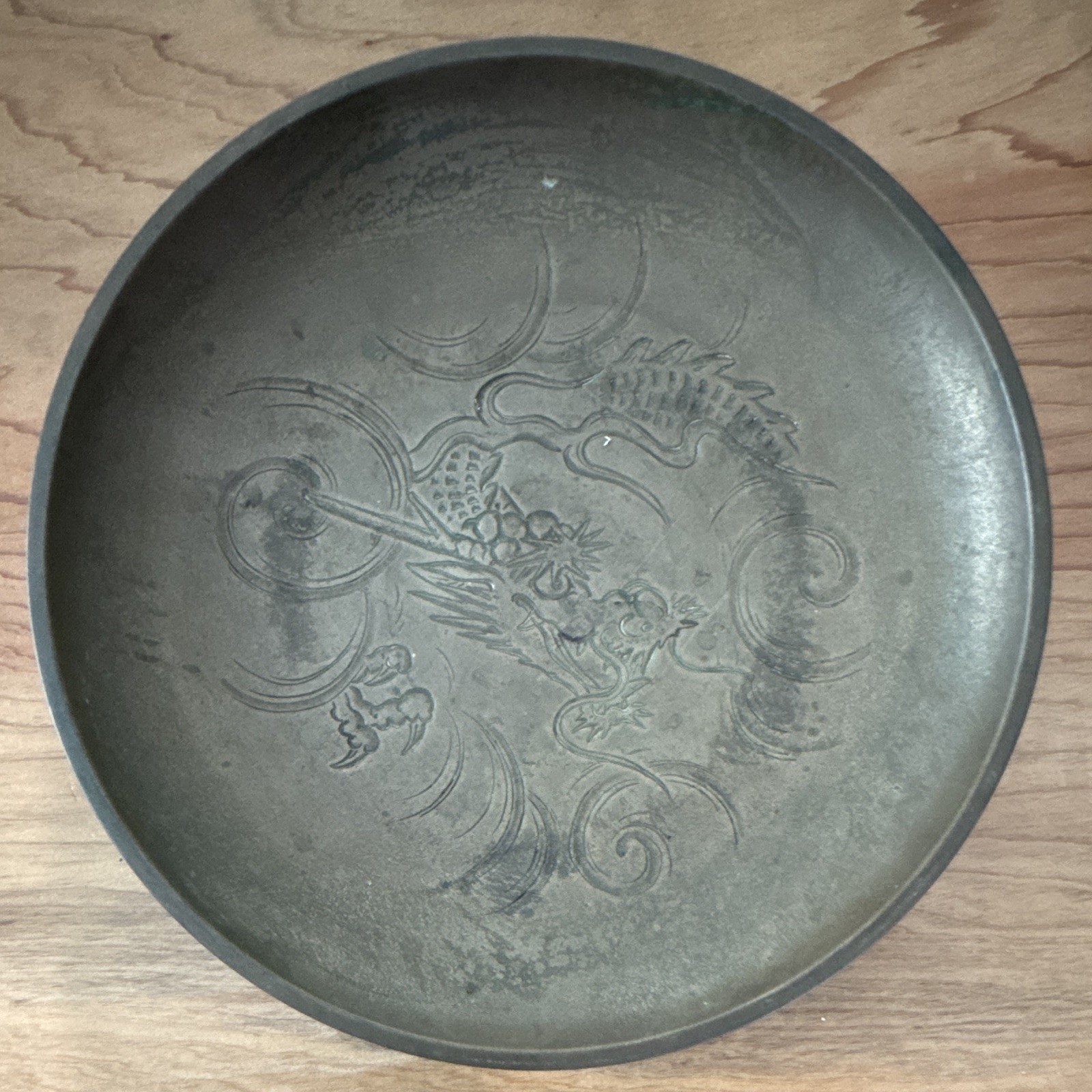 Vintage Chinese etched metal or brass decorative bowl featuring a dragon motif