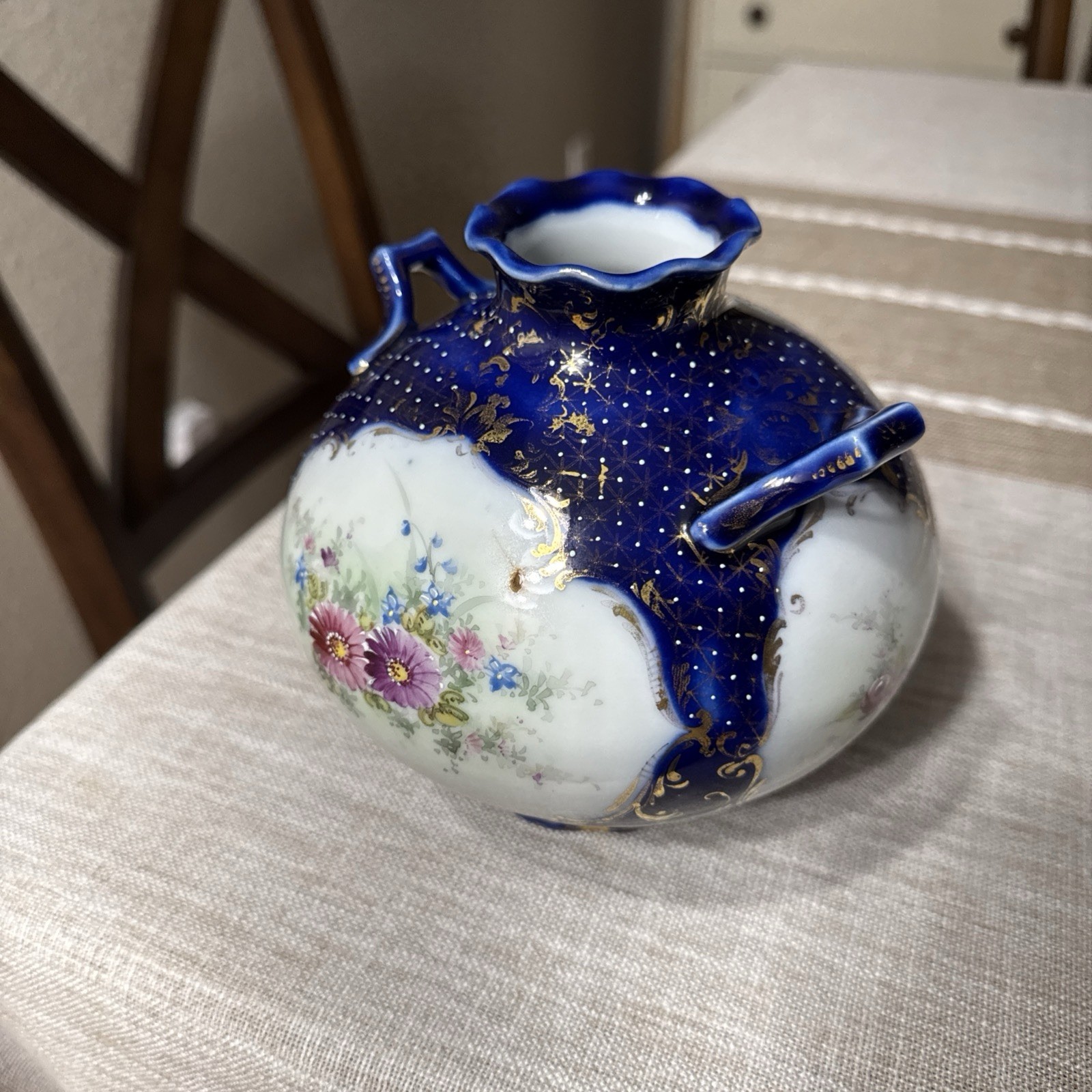 Cobalt blue antique porcelain vase featuring hand-painted floral details
