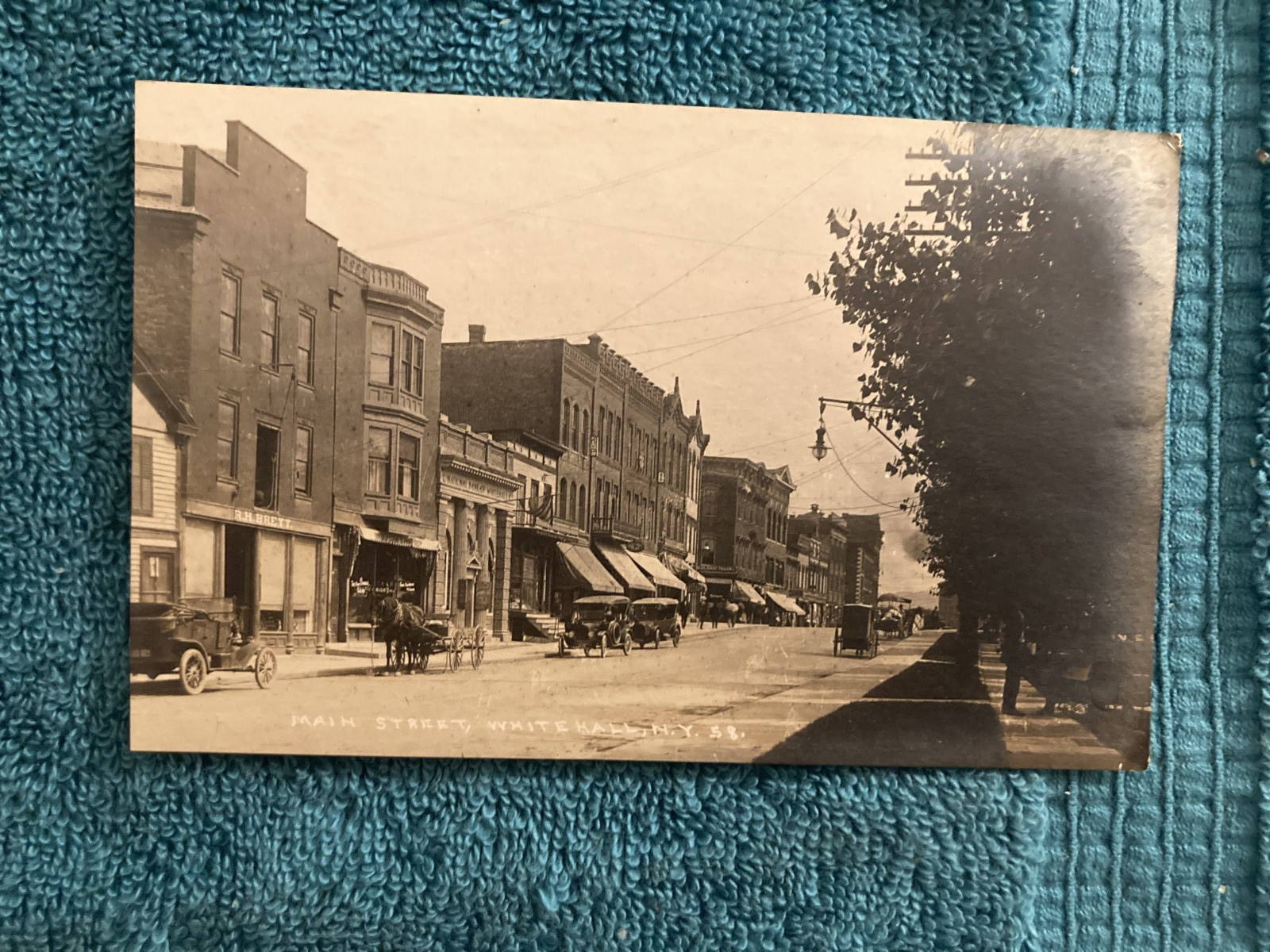 RPPC Whitehall New York Downtown View Showing Horse & Carriage with Autos c1910