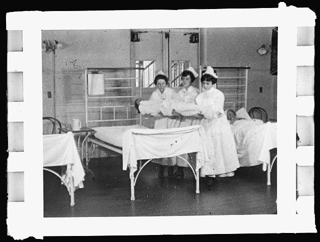 Photo:1910s Nurses with Baby in Hospital Ward Interior