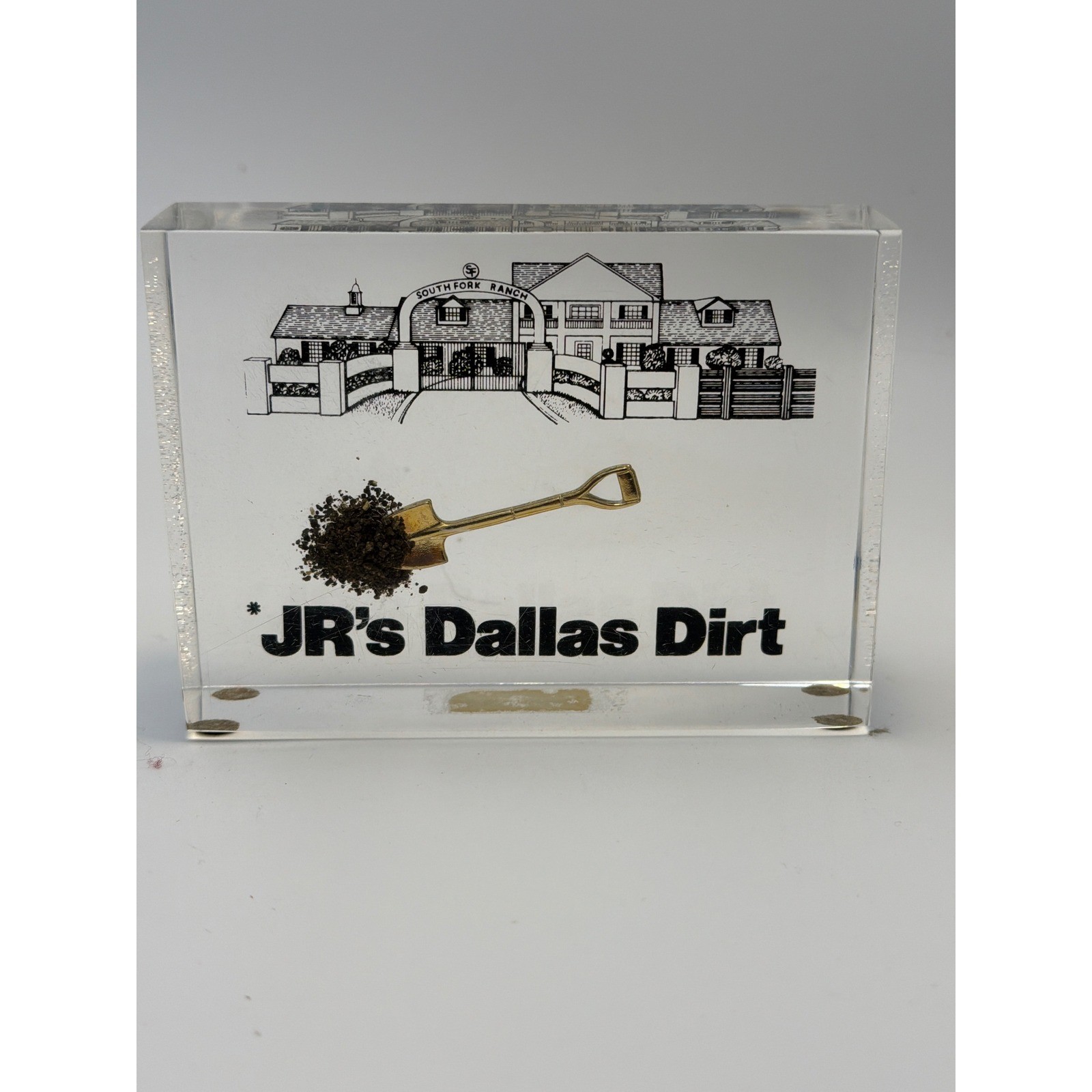 Vintage 1981 Dallas TV Show Southfork Ranch JR\'s Dallas Dirt Paperweight Lucite