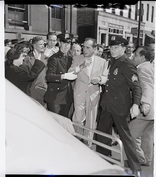 New York Humphrey Bogart convoyed police past crowds outside mid Ma- 1949 Photo