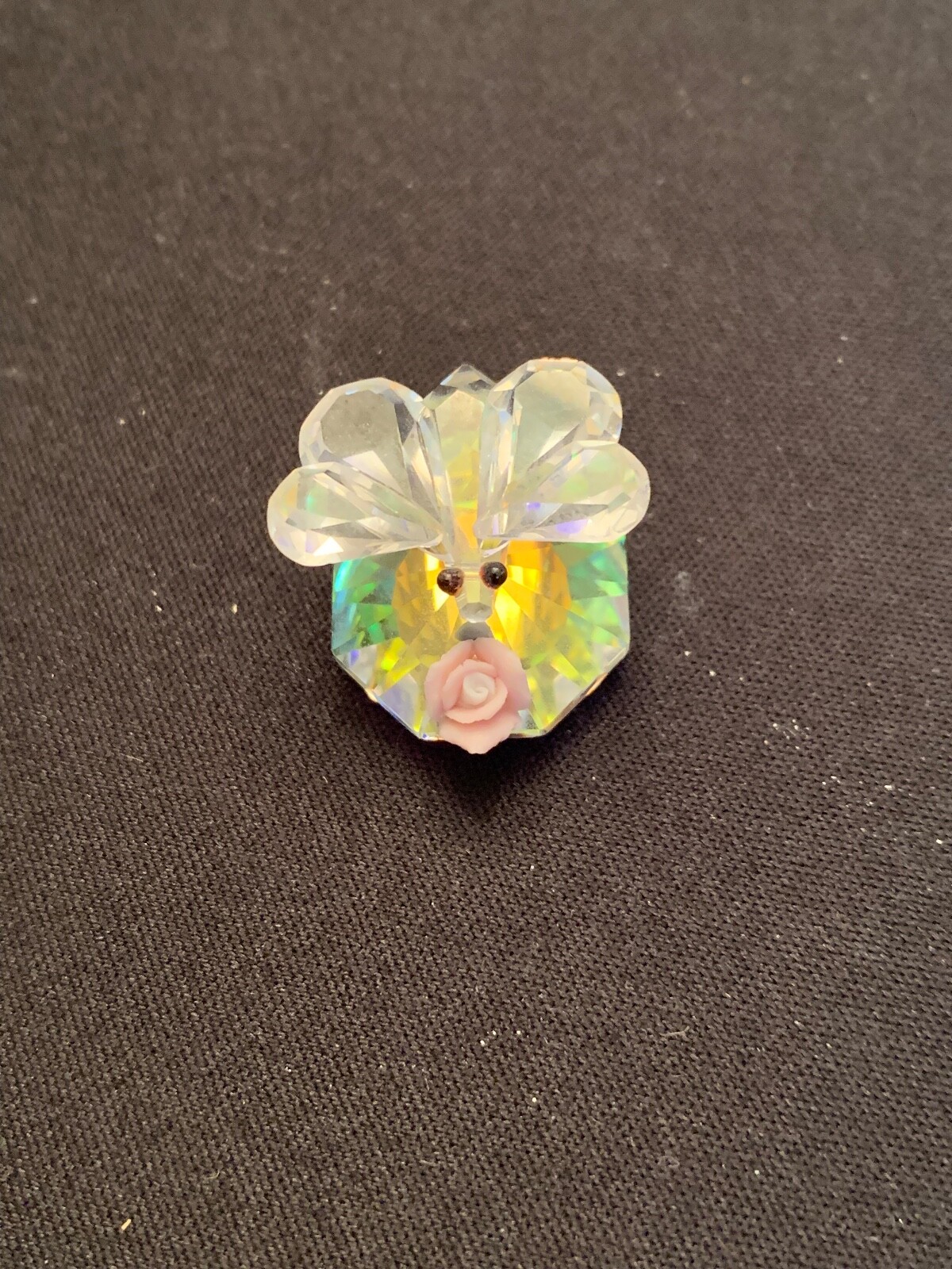 Glass bee with pink flower on mirror