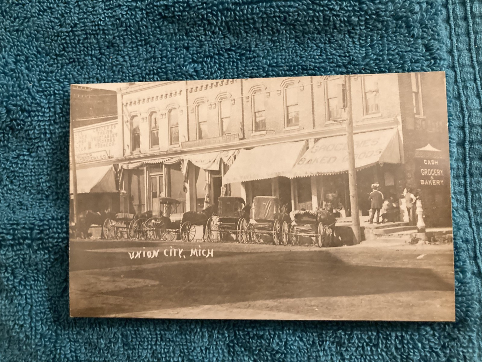 RPPC Union City Michigan Busy Grocery/Bakery Shop/Horse & Carriages c1910