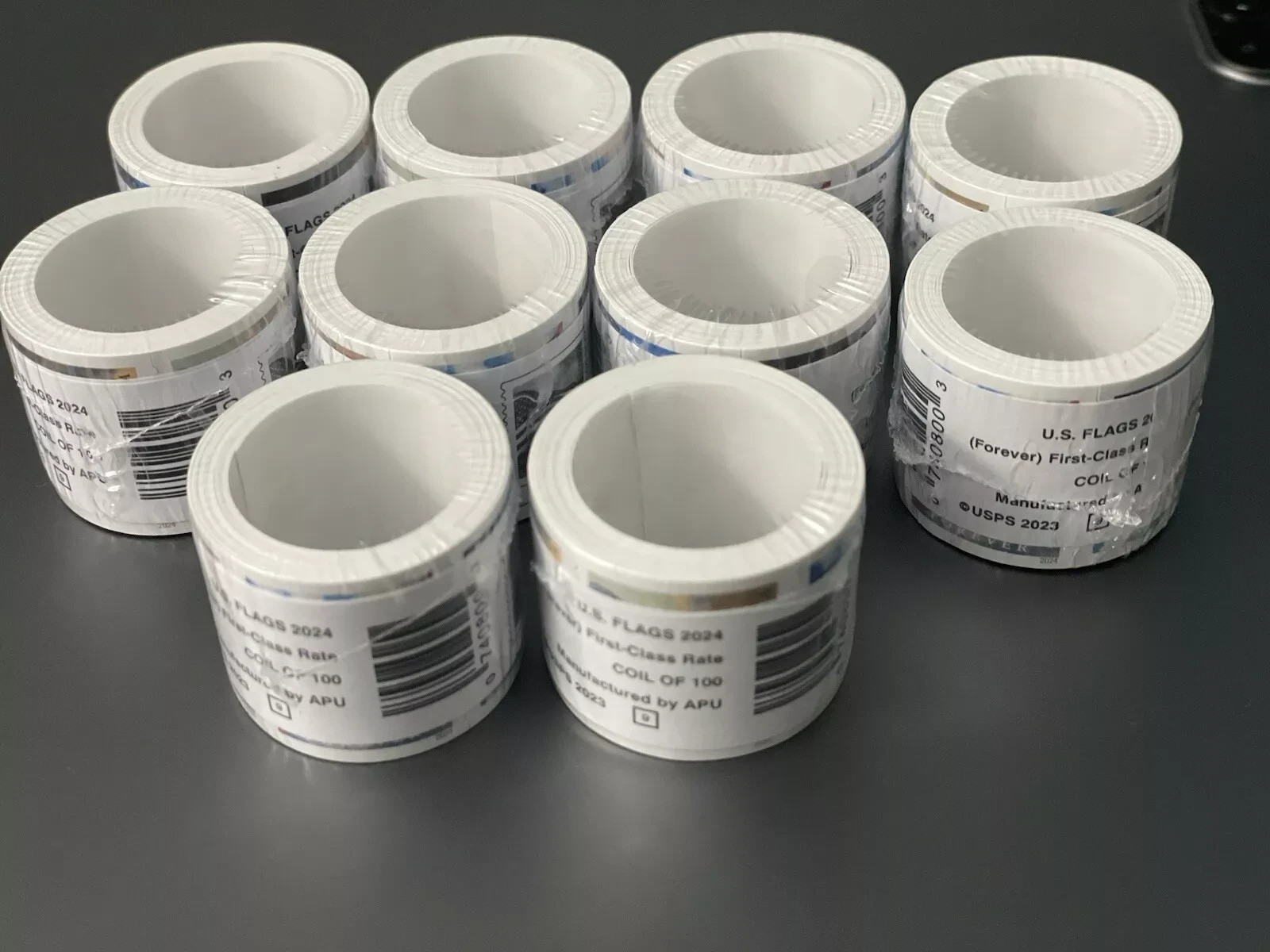 10 rolls of 100 USPS postage stamps, totaling 1000 pieces