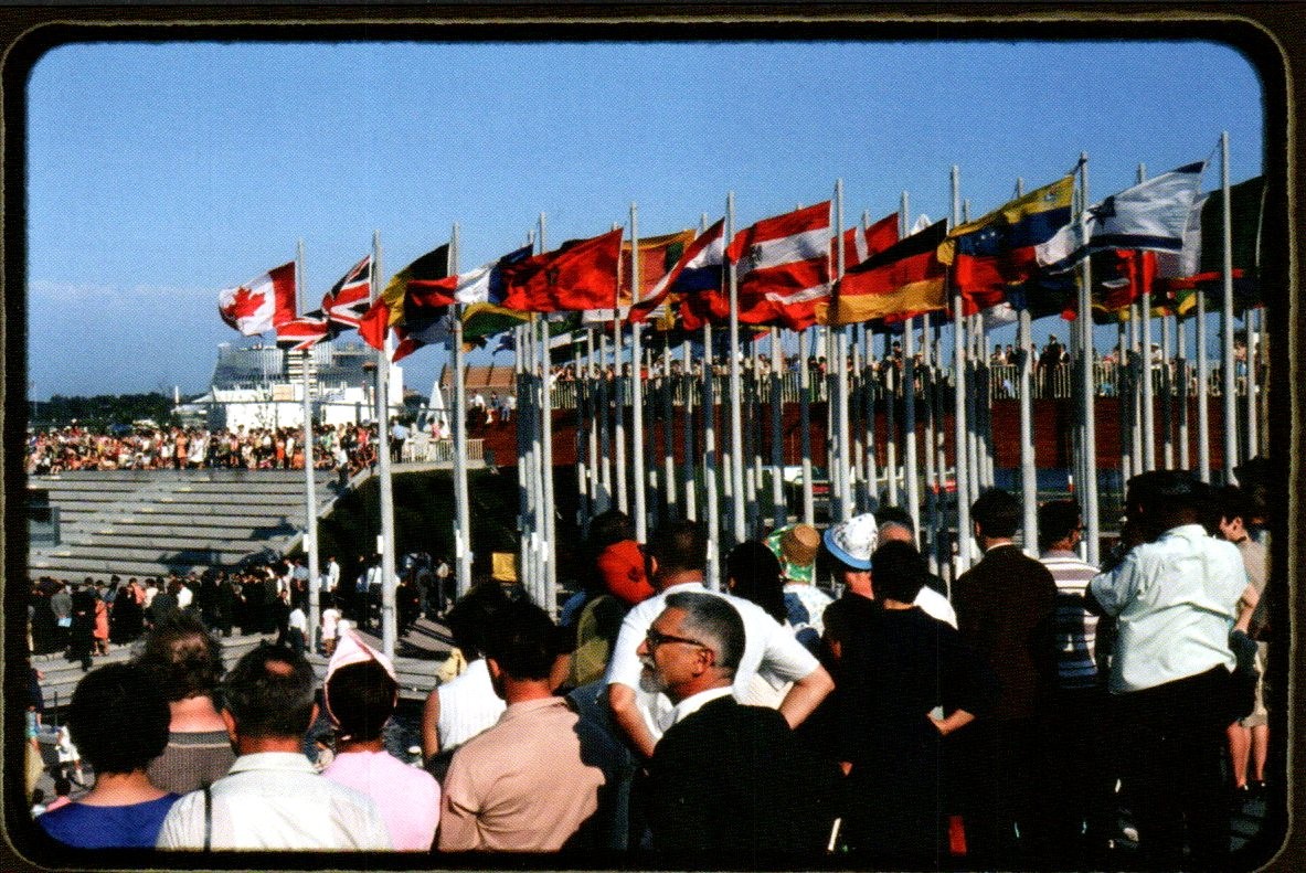 Montreal Expo 67 - Place des Nations world flags and crowd - Frund Postcard