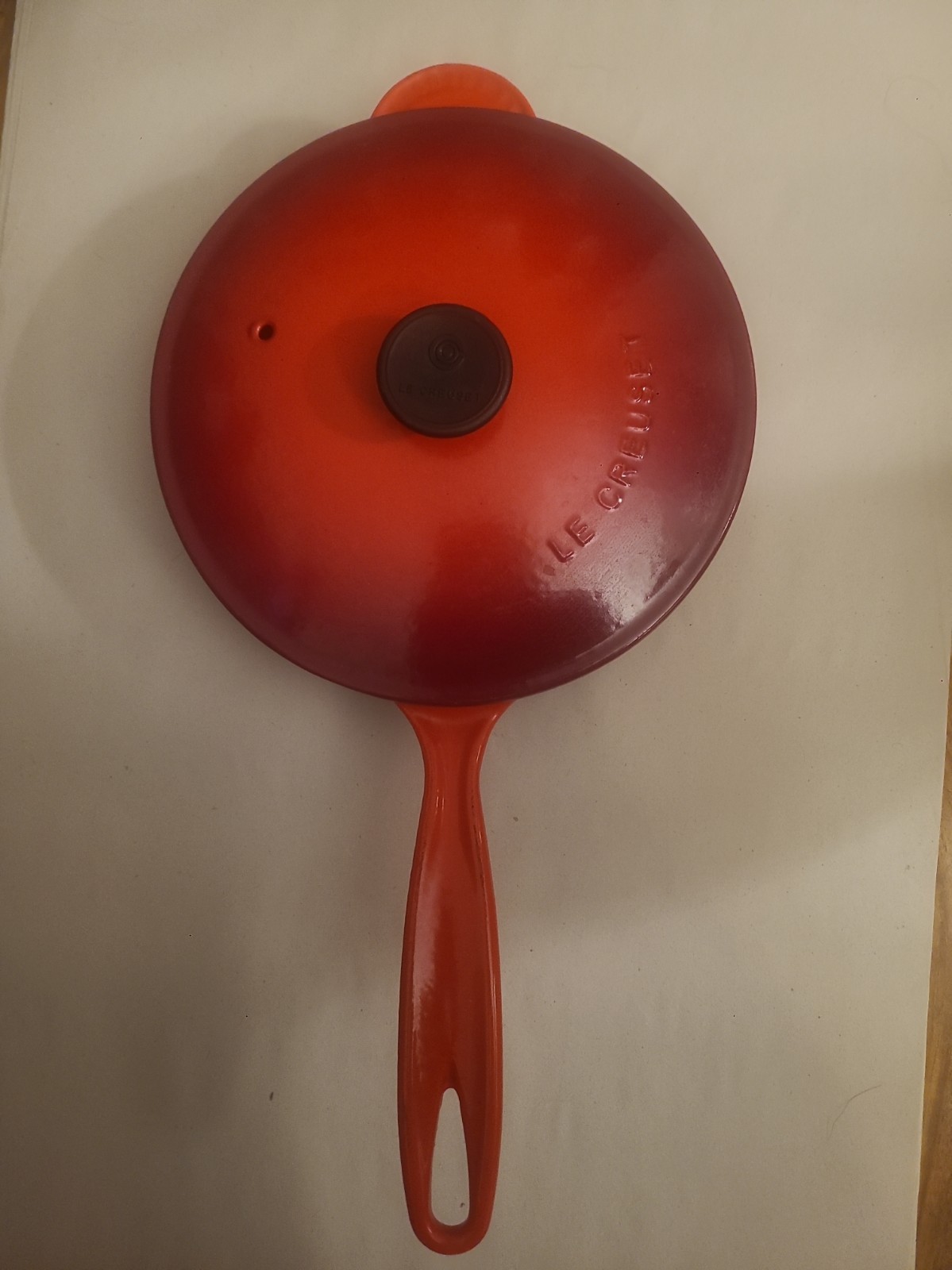 Le Creuset Enameled Cast Iron Saucier in the iconic Flame (orange-red gradient)