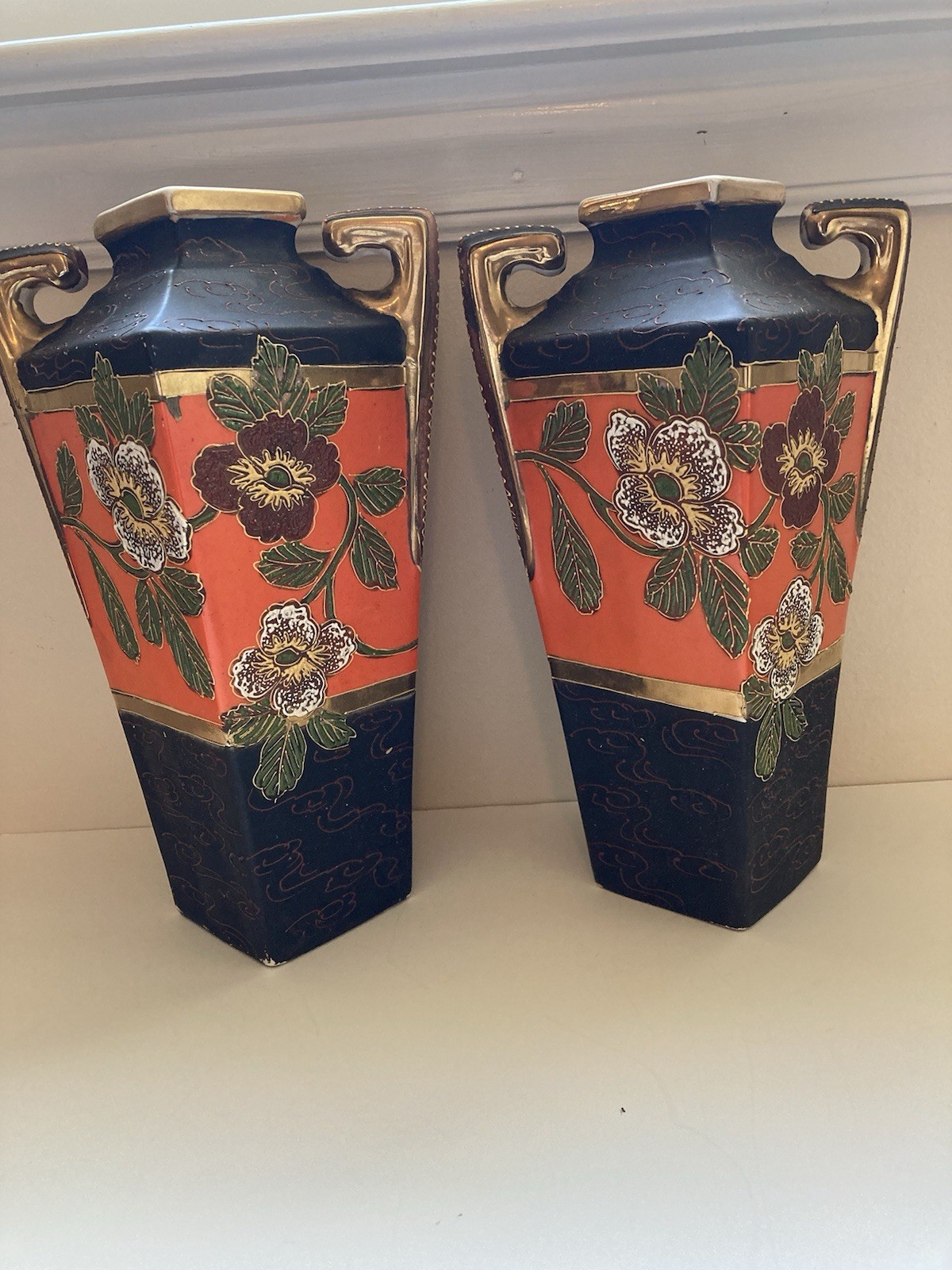A pair of hand painted Art Nouveau vases Japan. Approximately 10 inches tall.