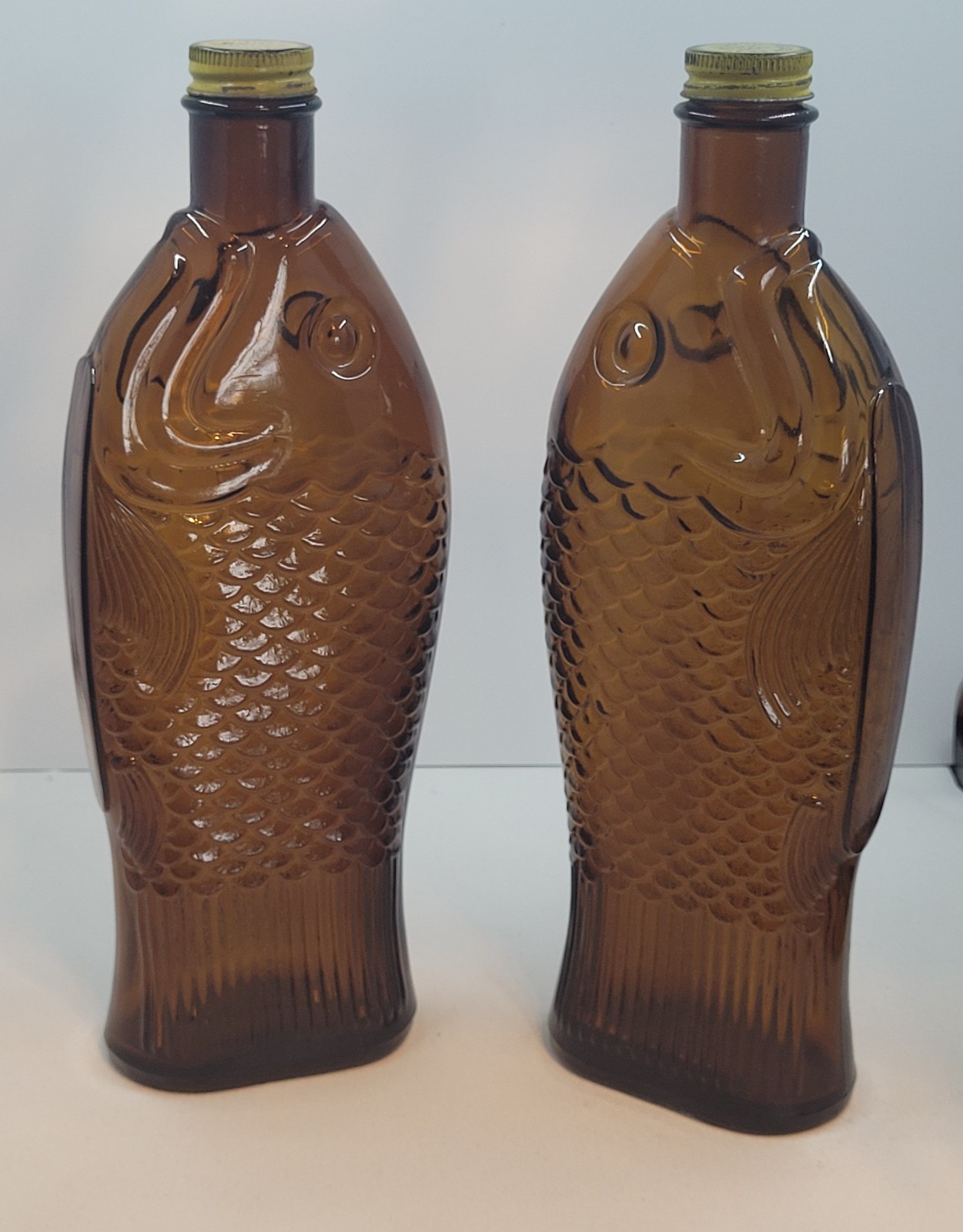 Pair of Vintage 1930s Fish shaped Amber Glass Cod Liver Oil bottle original cap