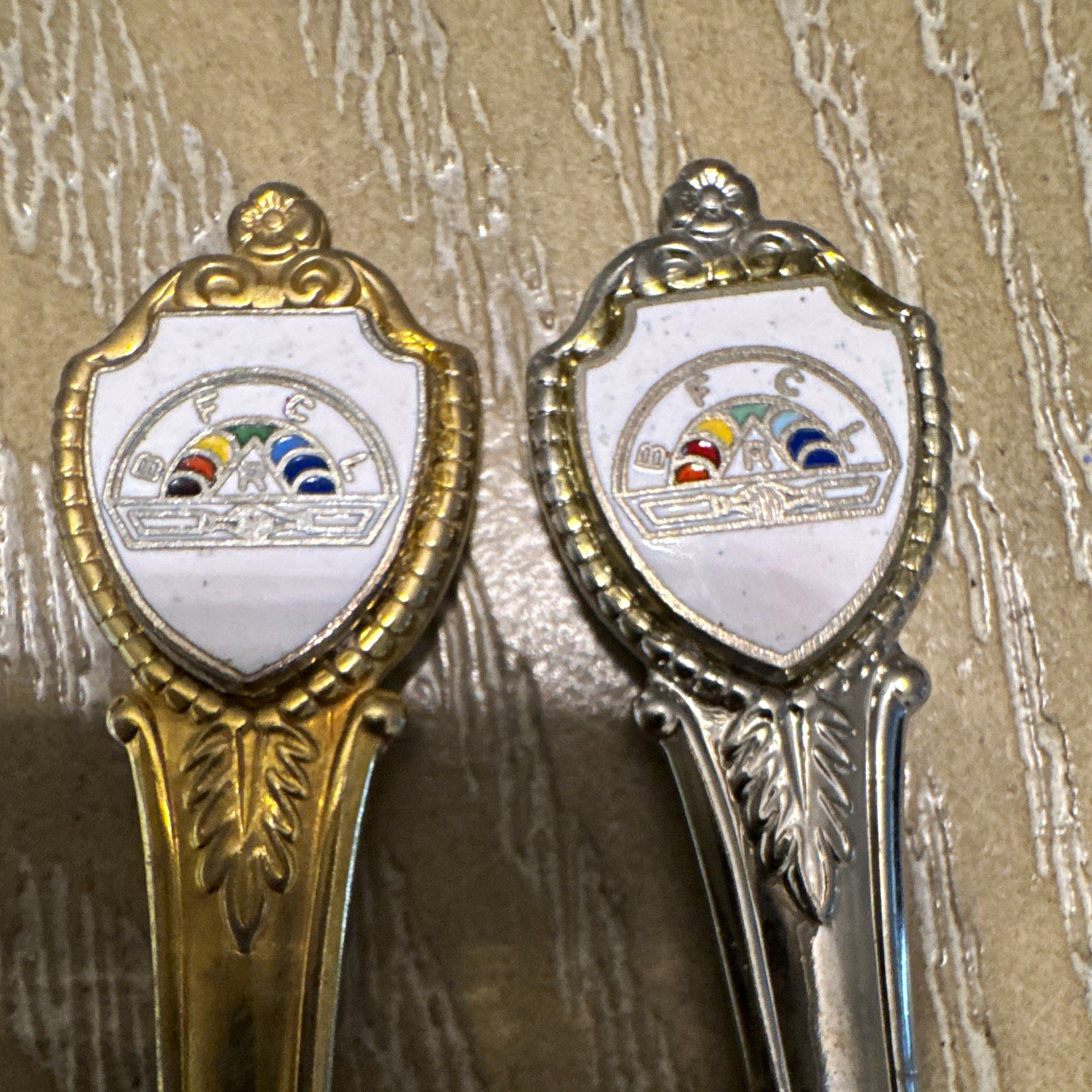 Lot of 2 Vintage Novelty Souvenir Spoons Shield Crest Handle Silver & Gold