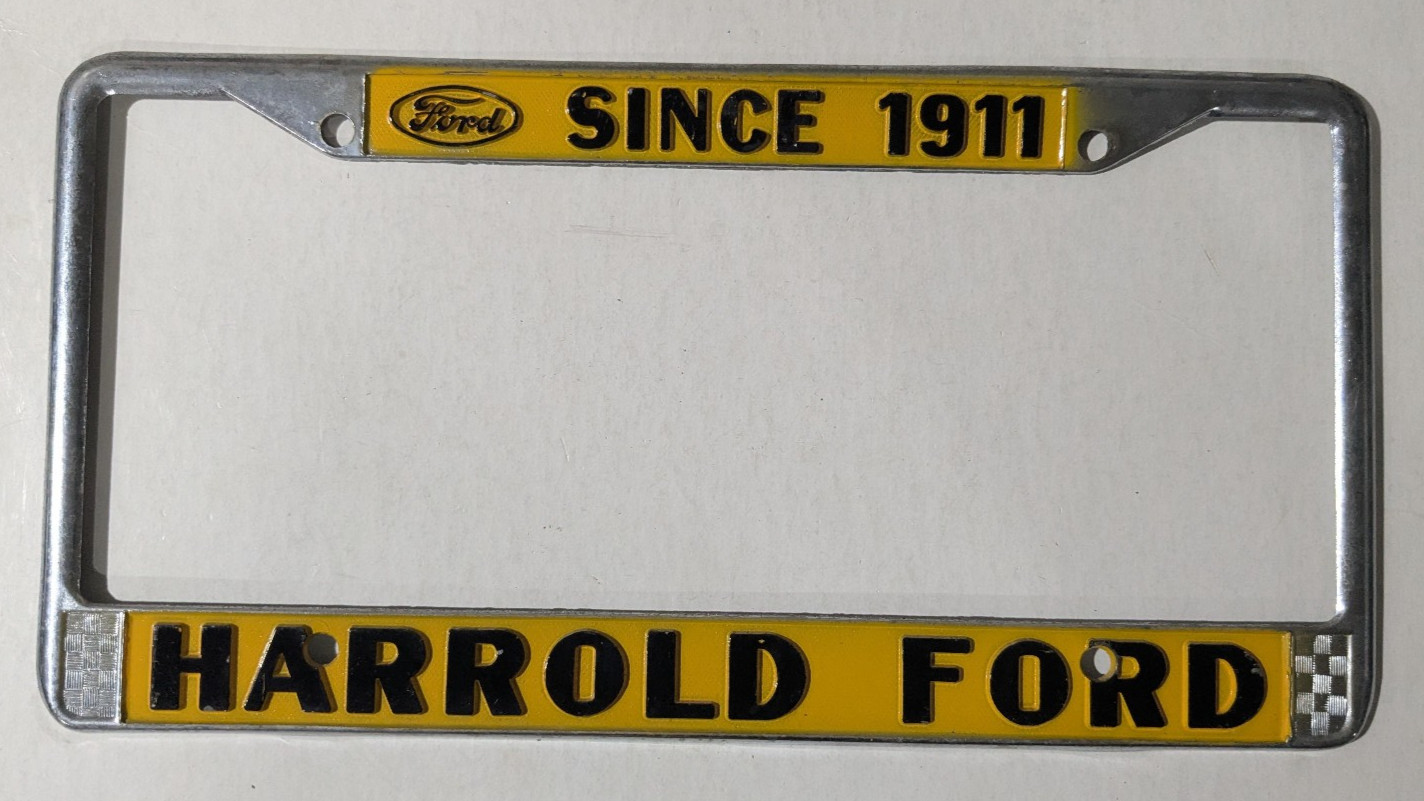 VTG Metal Yellow Harrold Ford Since 1911 Dealership Checker License Plate Frame