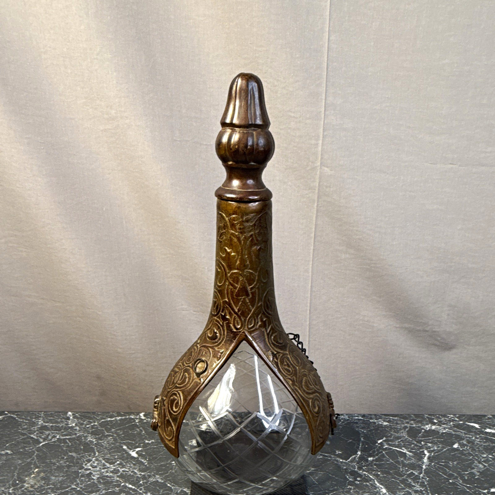 antique lock-caged claret or liquor decanter with bronze metal on cut glass