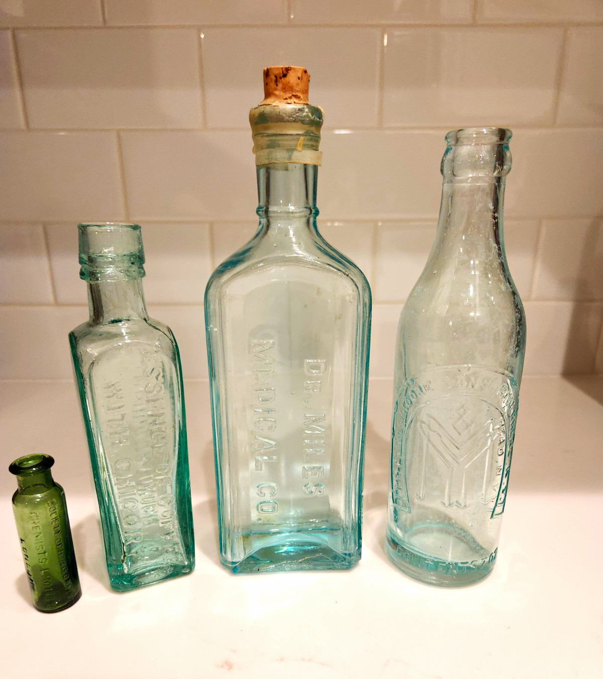 Lot of 4 Vintage Embossed Glass Bottles Aqua & Green incl. E.B. Miller Medical