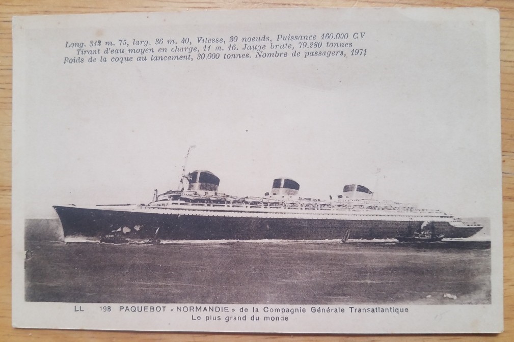 NORMANDIE (French) Port view at sea. Statistics in French on top c1935