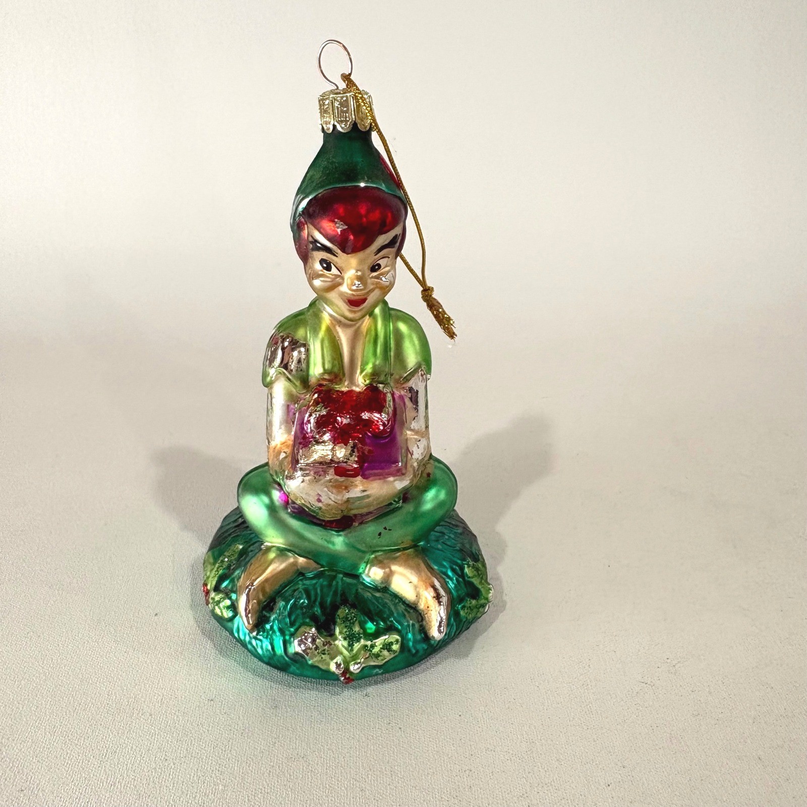Vintage Peter Pan Glass Christmas Ornament Seated Figure with Gift Green Red