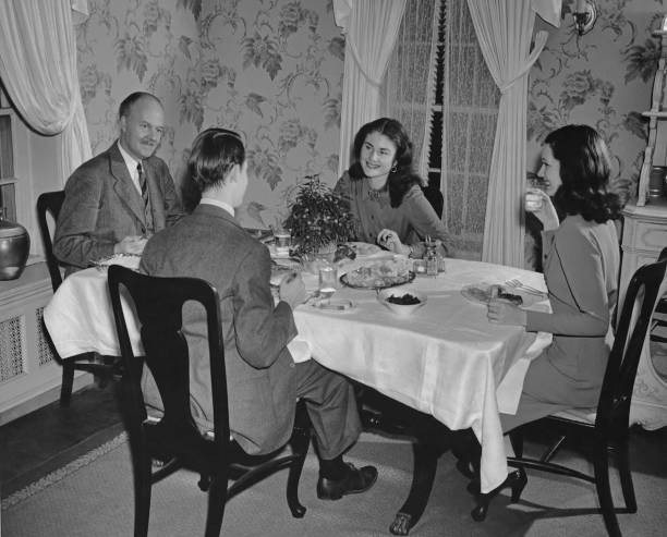 Two men and two women talking over dinner circa 1940 Historic Old Photo